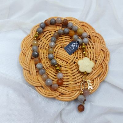 A 33-bead rosary made of agate stones, hematite spacers, and Chinese gold-plated chains.