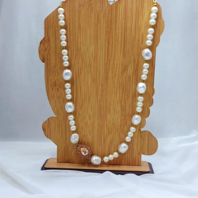 A necklace made of Majorca pearls and shell pearls.