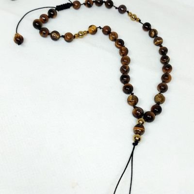 A mobile chain and prayer necklace made from tiger eye stones.