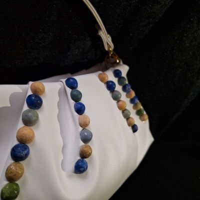 White leather bag inlaid with colored ceramics 