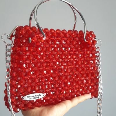 A bag of crystal beads with stainless steel handles and chain