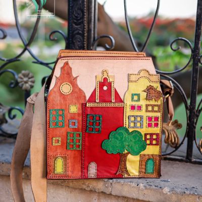 A natural leather bag with colorful houses on it