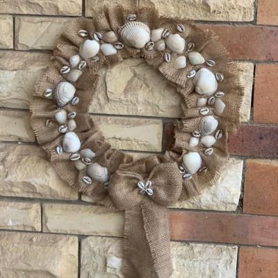 A burlap hoop inlaid with seashells