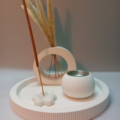 n elegant white set with a spherical incense burner and an incense holder to add a calm atmosphere in your home