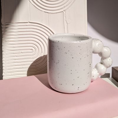 White mug with bubbles hand