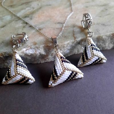 A set of white symmetrical triangle shaped by Miyuki beads