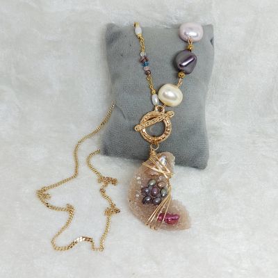 "A necklace made of quartz stones and shell pearls.