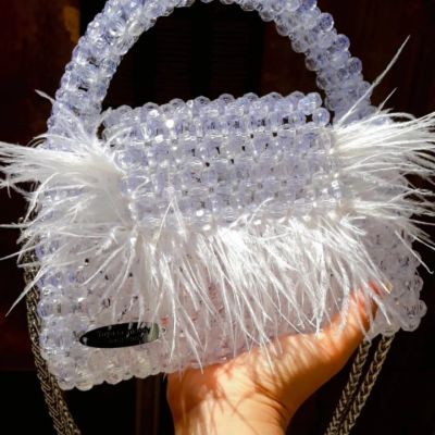 Crystal clear bag with feathers and fixed handle