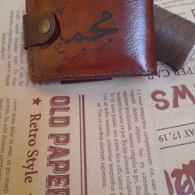 A men's pocket wallet made of natural leather with the name and photo engraved on it 