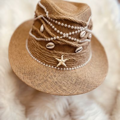 A summer hat decorated with shells and pearls