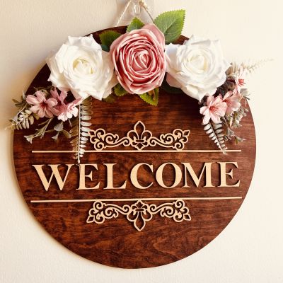 A decorative piece with the word welcome on it