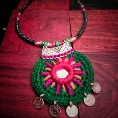 A necklace made of thread with a metal pendant, excellent quality. 