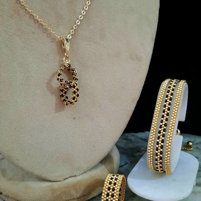 A delicate collection of gold and black Miyuki beads